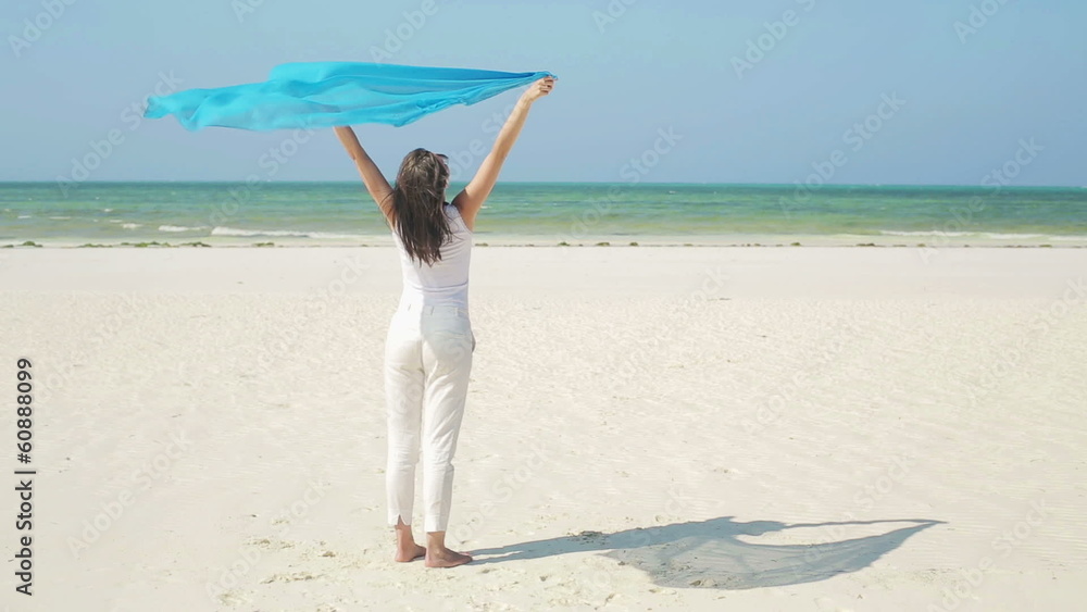 Young woman with pareo standing on beautiful exotic beach Young woman with pareo standing on beautiful exotic beach