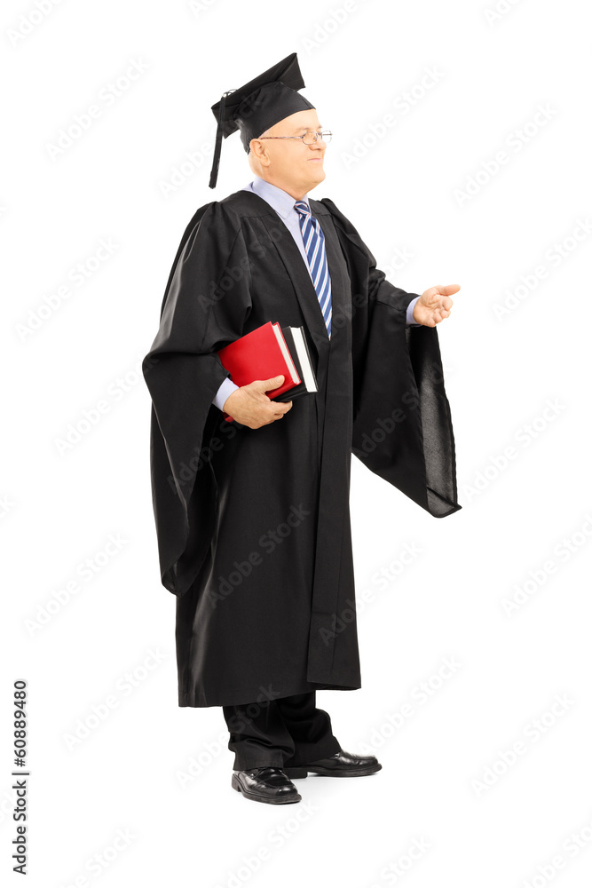 College professor in graduation gown holding books College professor in graduation gown holding books