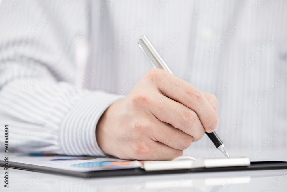 man hand with pen and business report man hand with pen and business report