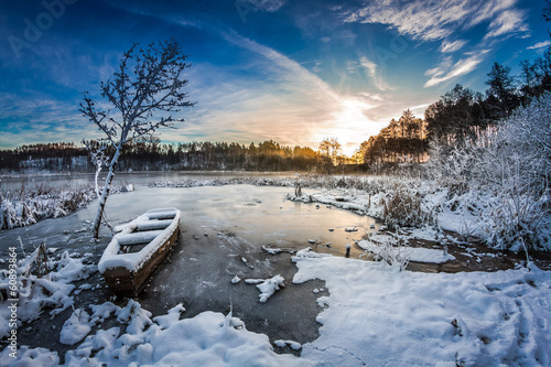 Sunrise on winter lake covered with snow © shaiith