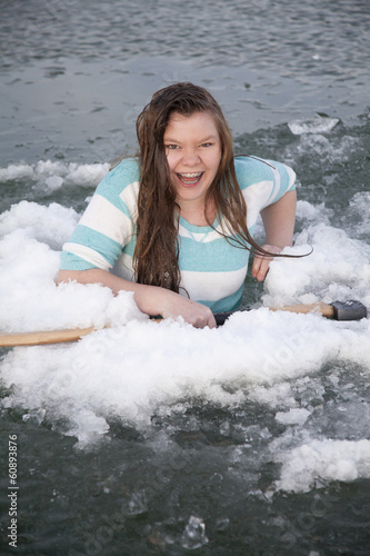 gilr in ice hold with axe laughing © Poulsons Photography