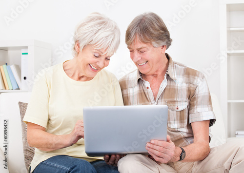 Senior Couple Looking At Laptop
