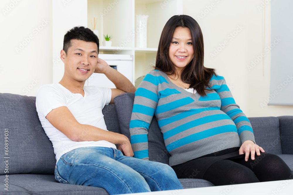 Pregnant woman and husband at home Pregnant woman and husband at home