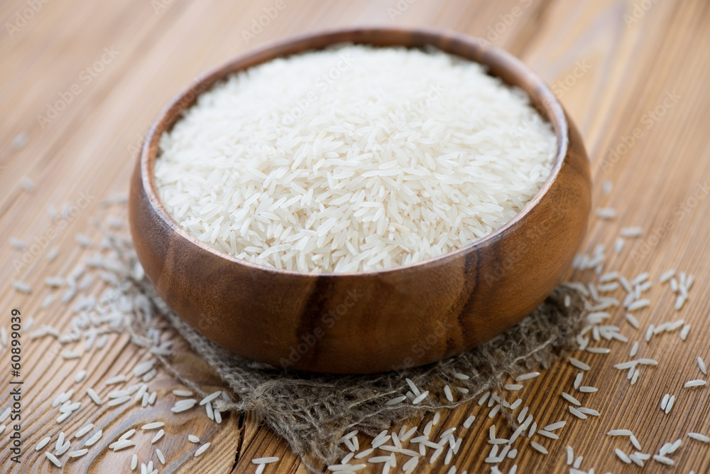 Wooden bowl with basmati kernels, horizontal shot Wooden bowl with basmati kernels, horizontal shot