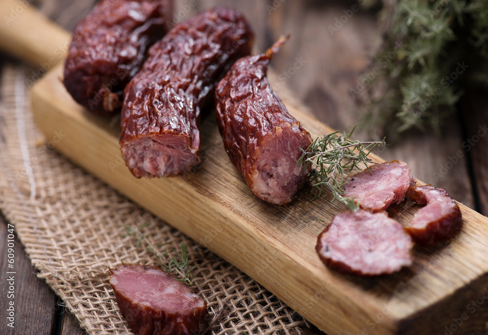 Dried sausage on kitchen plank