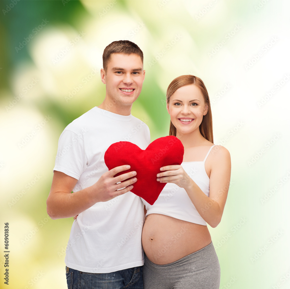 happy young family expecting child with big heart