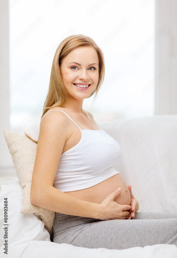 happy pregnant woman touching her belly