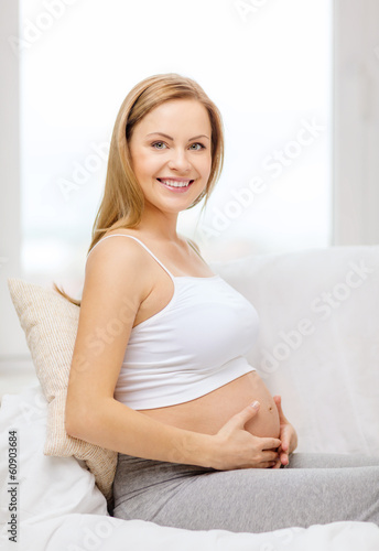 happy pregnant woman touching her belly
