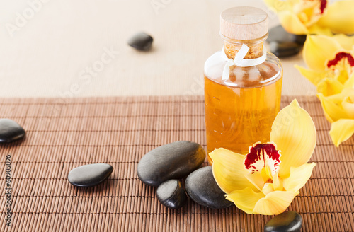 Fototapeta Naklejka Na Ścianę i Meble -  essential oil, massage stones and orchid flowers