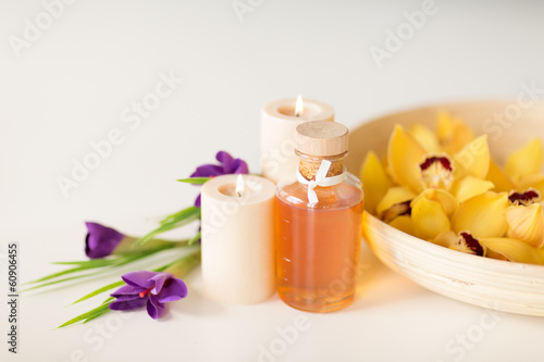 orchid flowers in bowl  oil  candles and irises