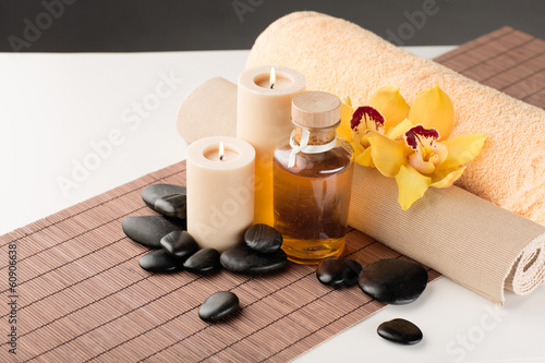 Fototapeta Naklejka Na Ścianę i Meble -  essential oil, massage stones and orchid flower