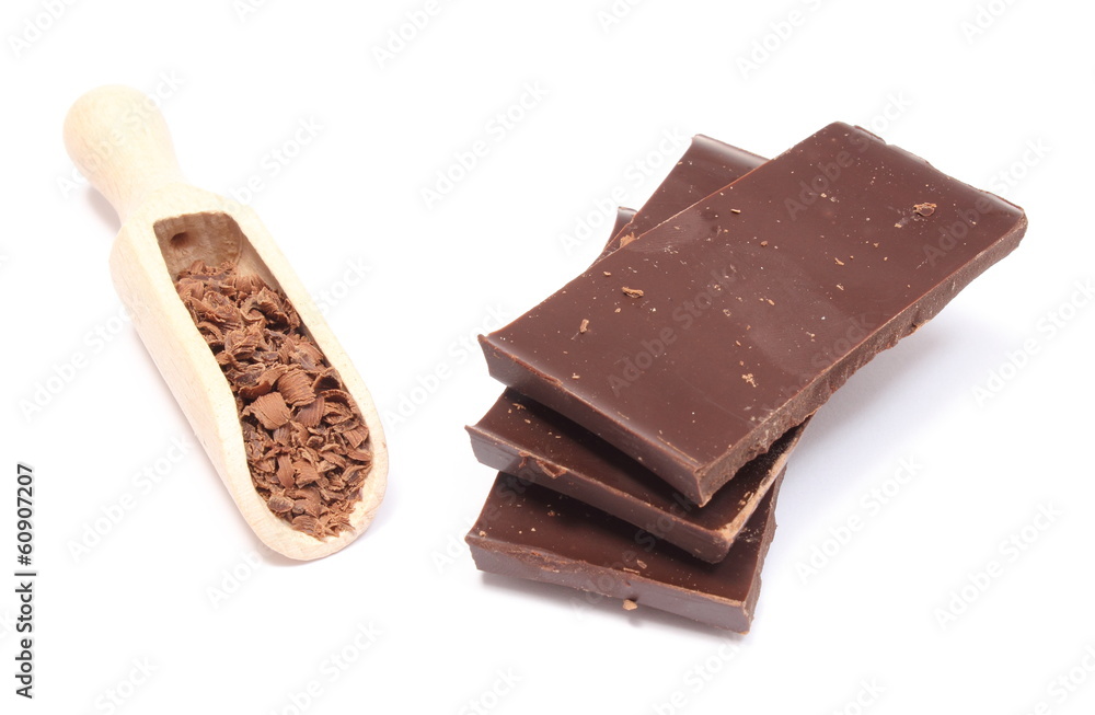 Stack of dark chocolate and grated on wooden spoon Stack of dark chocolate and grated on wooden spoon