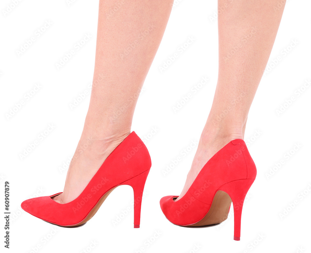 Beautiful female legs in red shoes isolated on white Beautiful female legs in red shoes isolated on white