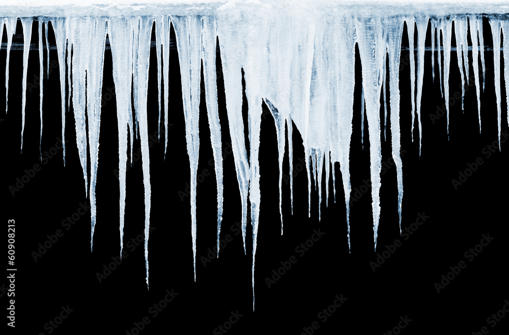 Obraz premium Group of icicles hanging on black background