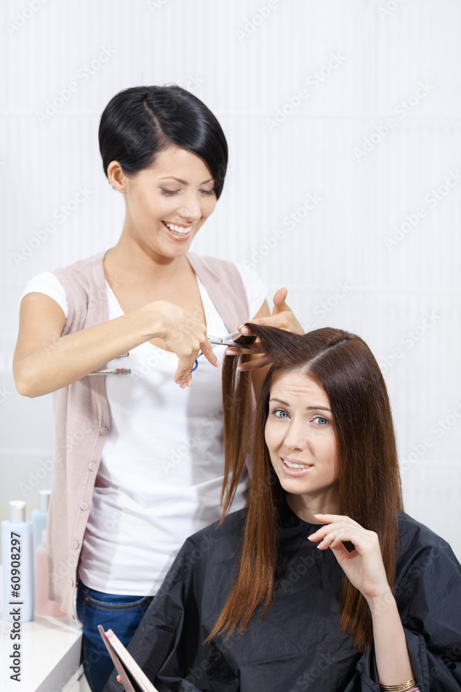 Beautician cuts hair of woman in hairdress salon Beautician cuts hair of woman in hairdress salon