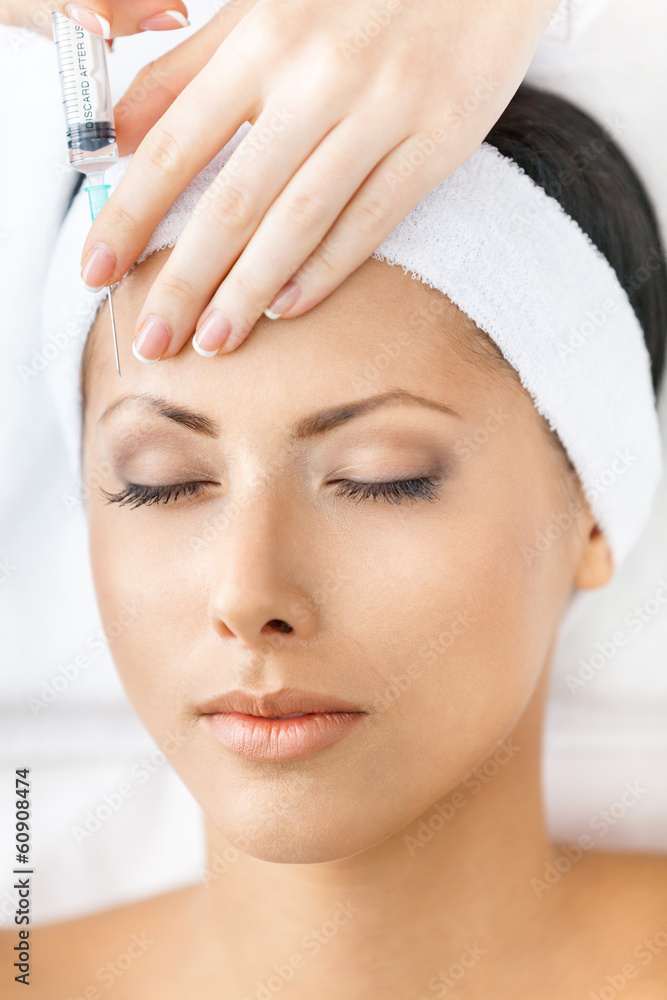 Headshot of woman with closed eyes getting injections Headshot of woman with closed eyes getting injections