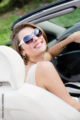 Portrait of pretty woman in sunglasses sitting in the car © Karramba Production