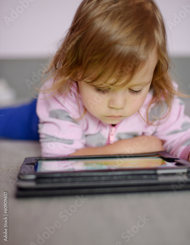 toddler girl using tablet pc