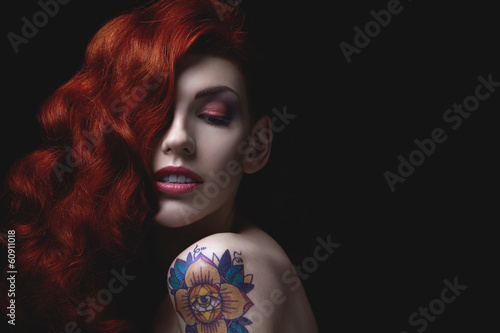 Sensual portrait of beautiful girl with tattoo