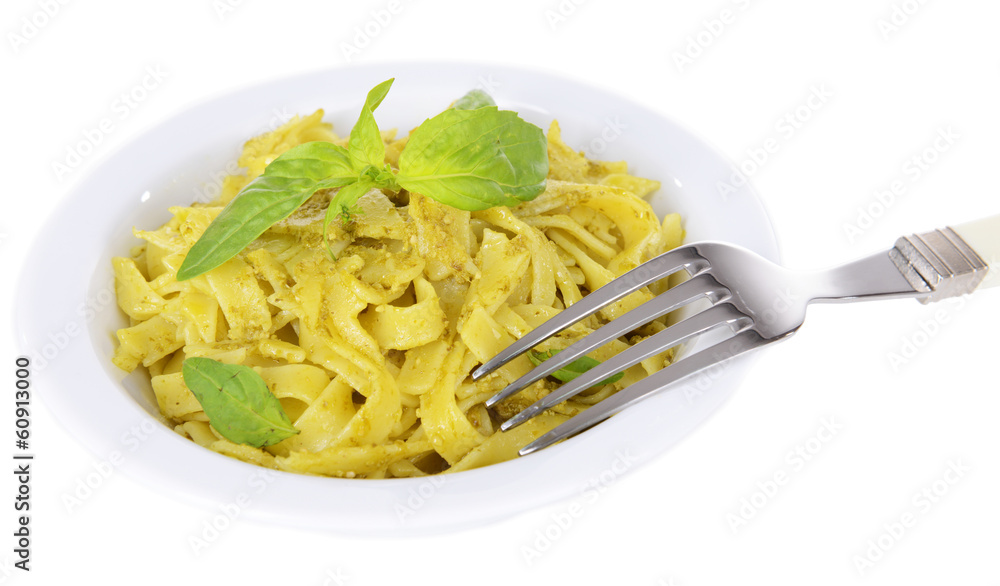 Delicious pasta with pesto on plate isolated on white Delicious pasta with pesto on plate isolated on white