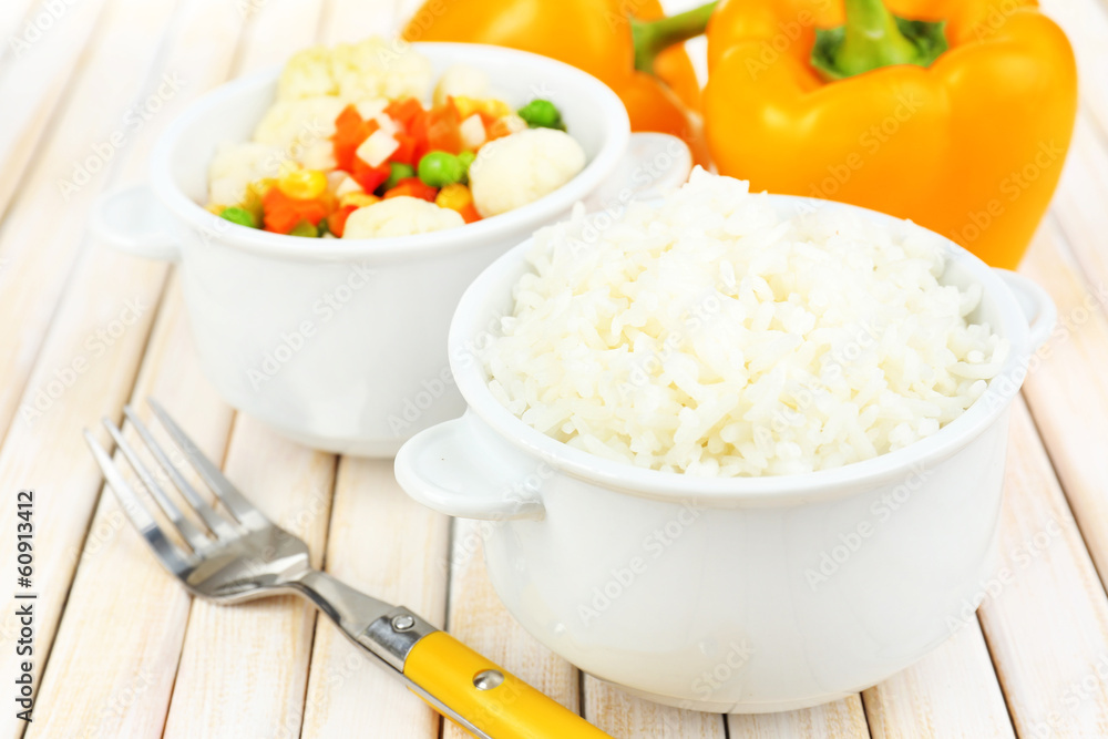Cooked rice with vegetables on wooden table close up Cooked rice with vegetables on wooden table close up