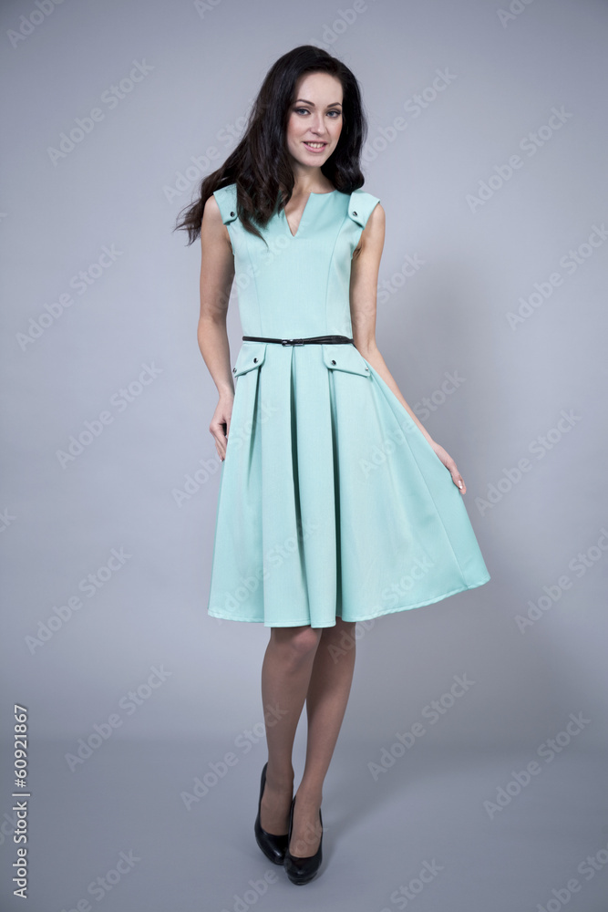 Beautiful young woman in a turquoise dress