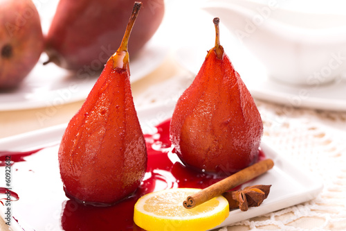 Two poached pears in red wine