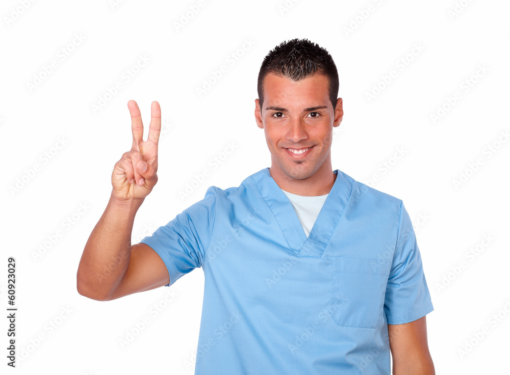 Excited male nurse smiling with victory sign Excited male nurse smiling with victory sign