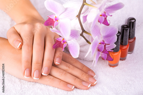 beautiful manicure with pink orchid on the white towel