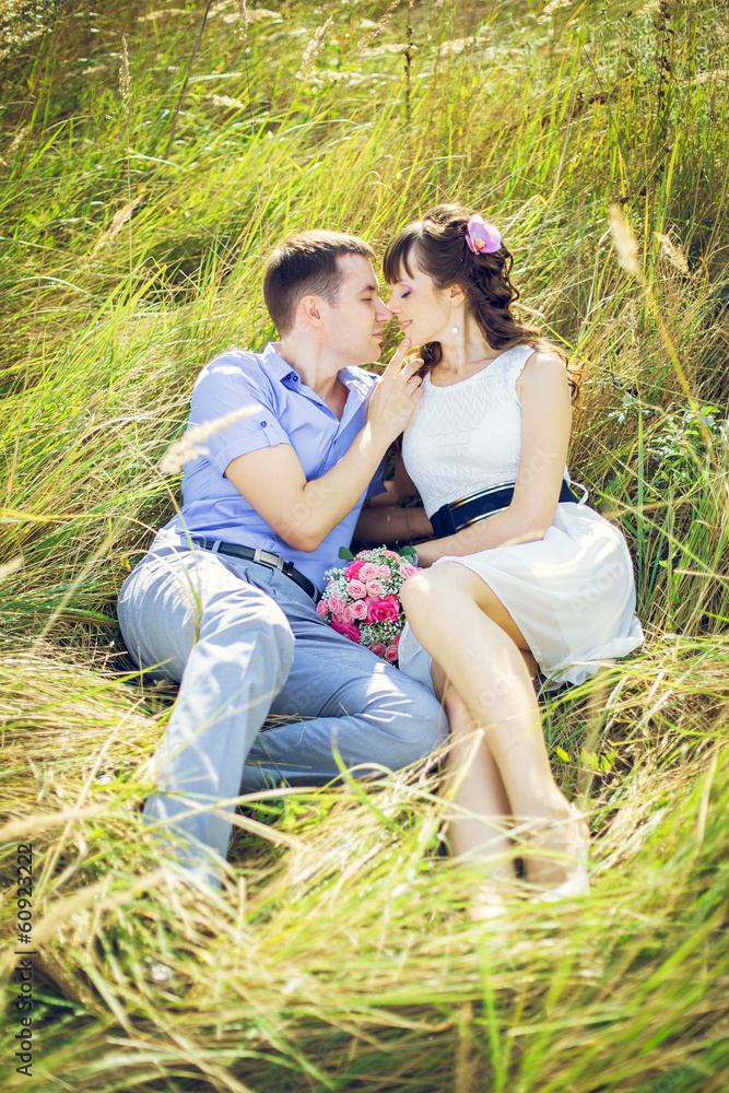 Fototapeta premium Girl with a guy lying in the tall grass