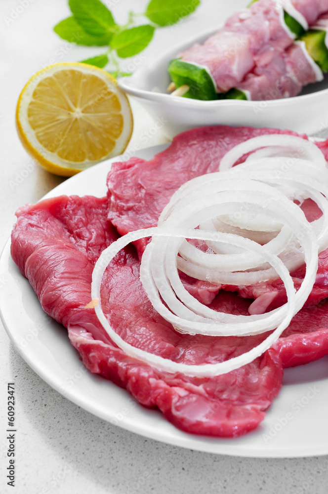 raw beef fillets and chicken meat skewers raw beef fillets and chicken meat skewers