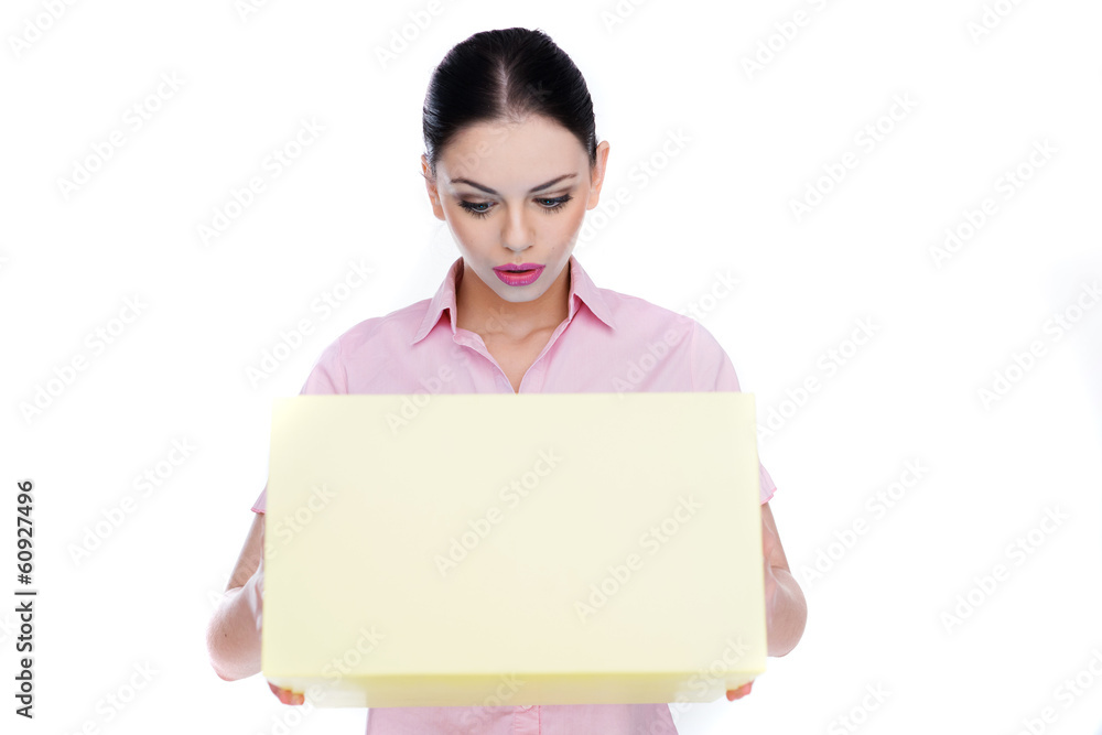 Young woman looking in amazement into a box Young woman looking in amazement into a box