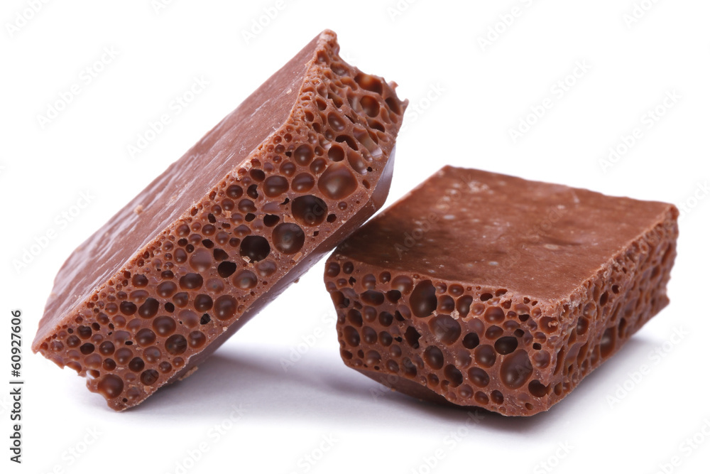 Porous black chocolate isolated on white close-up Porous black chocolate isolated on white close-up