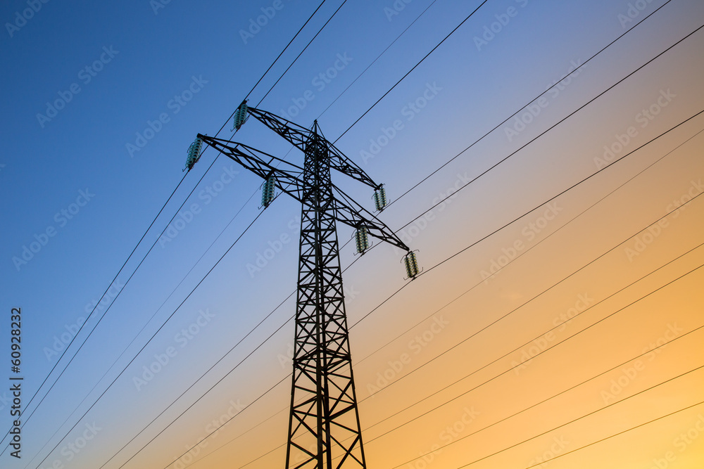 Electric power lines against blue and yellow sky