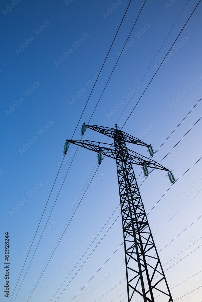 Electric power lines against blue sky