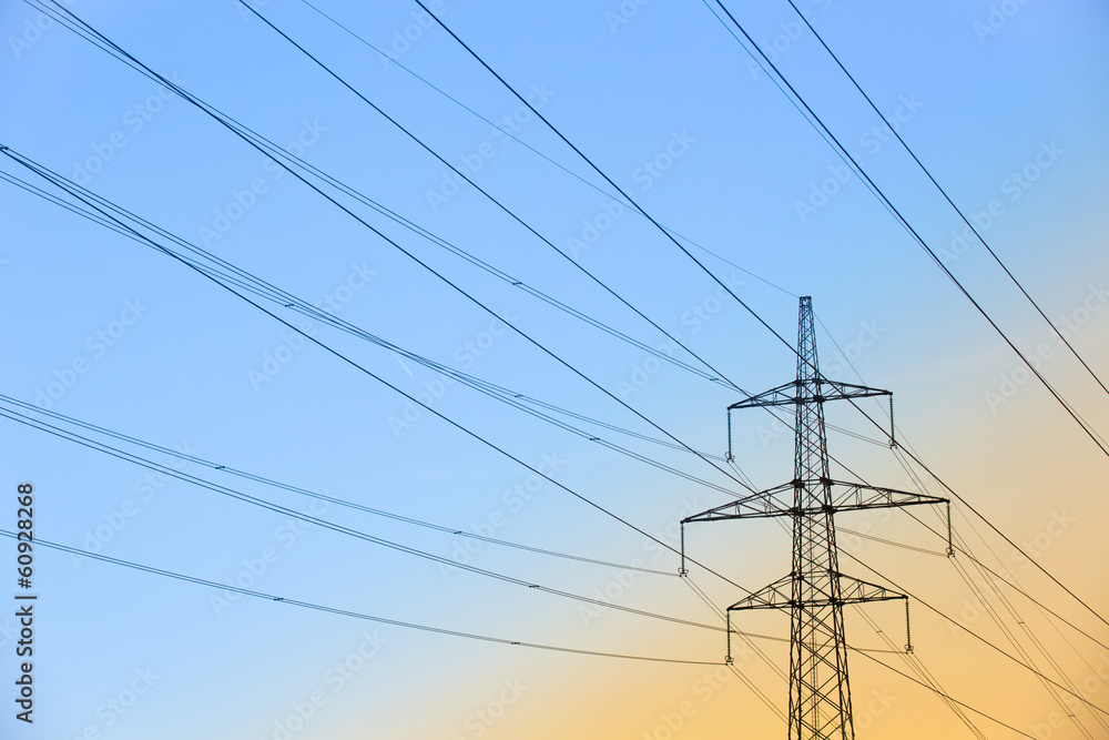 Electric power lines against blue and yellow sky