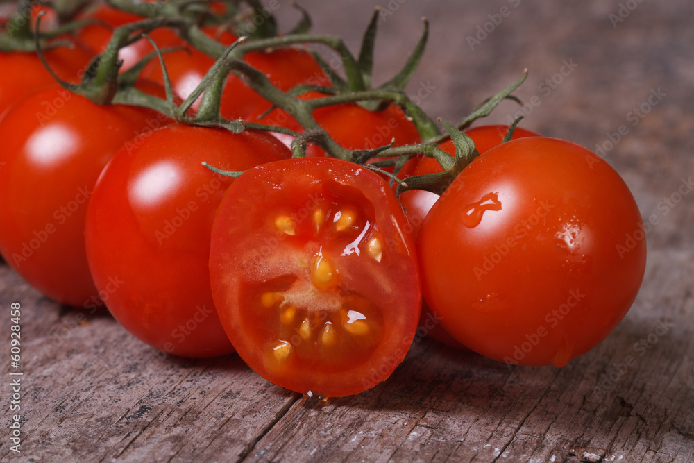 ripe tomatoes and one sliced fruit close up. horizontal ripe tomatoes and one sliced fruit close up. horizontal