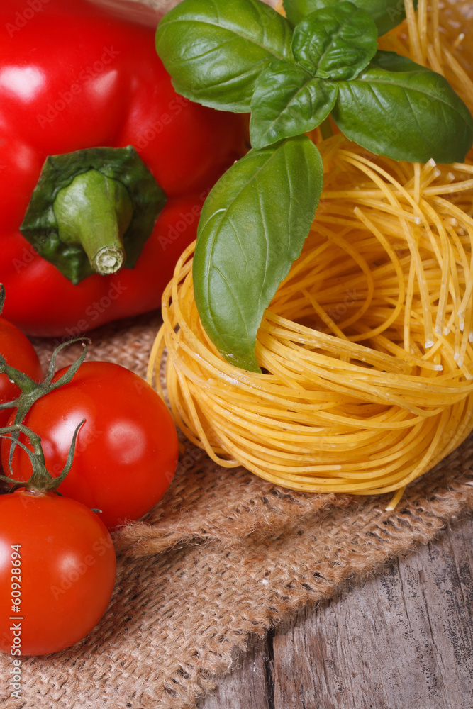 ripe tomatoes, dried pasta, fresh basil and pepper closeup ripe tomatoes, dried pasta, fresh basil and pepper closeup