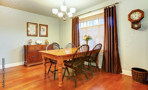 Beautiful cozy dining room decorated with rustic wall clock