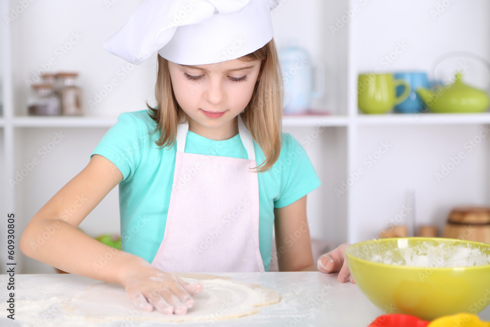 Little girl preparing cake dough in kitchen at home Little girl preparing cake dough in kitchen at home