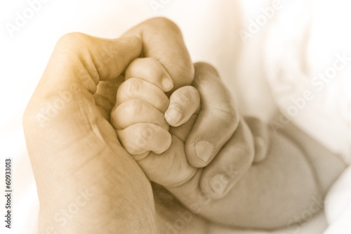 Father holding baby's hand