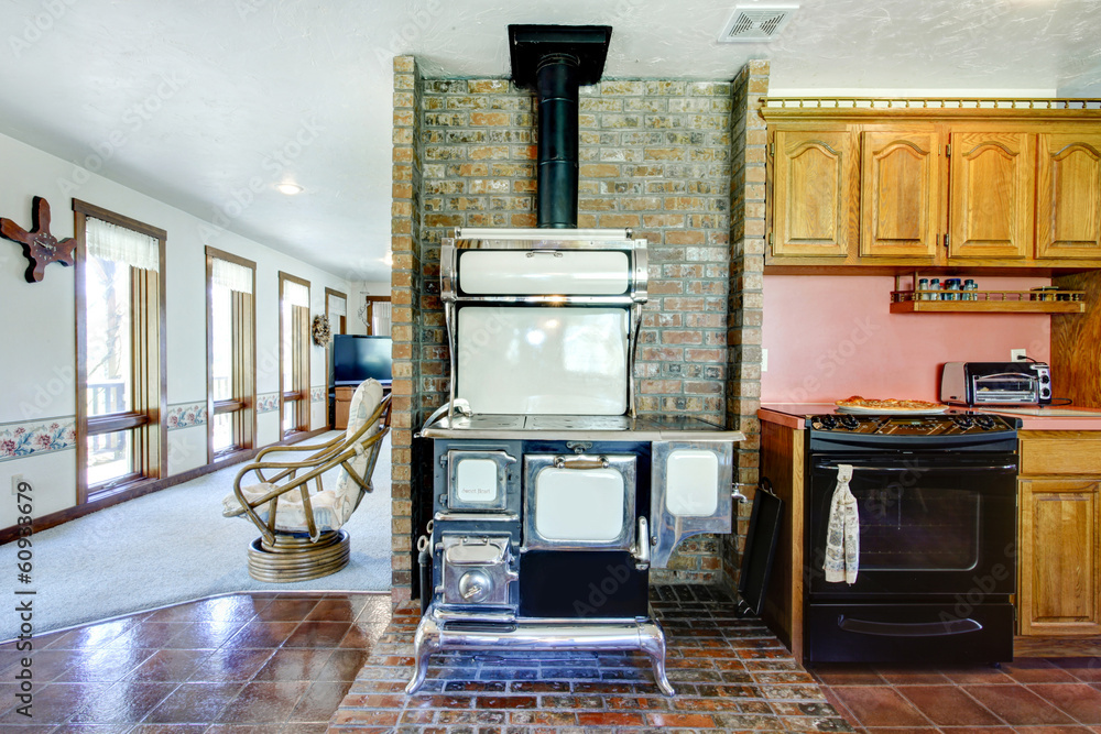 Farmhouse kitchen room with antique stove and brick background w Stock