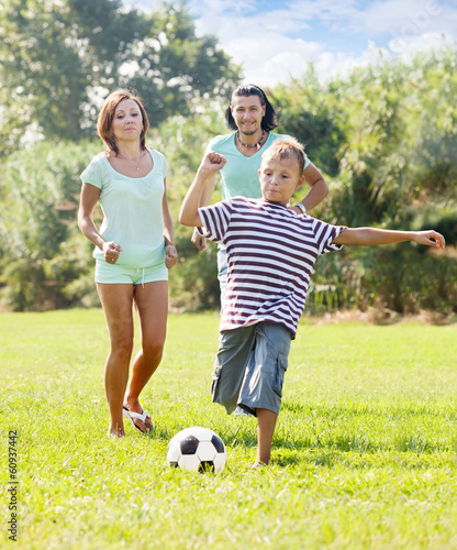teenage boy with parents playing in soccer