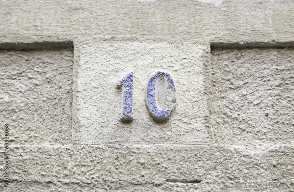 Number ten on a stone wall