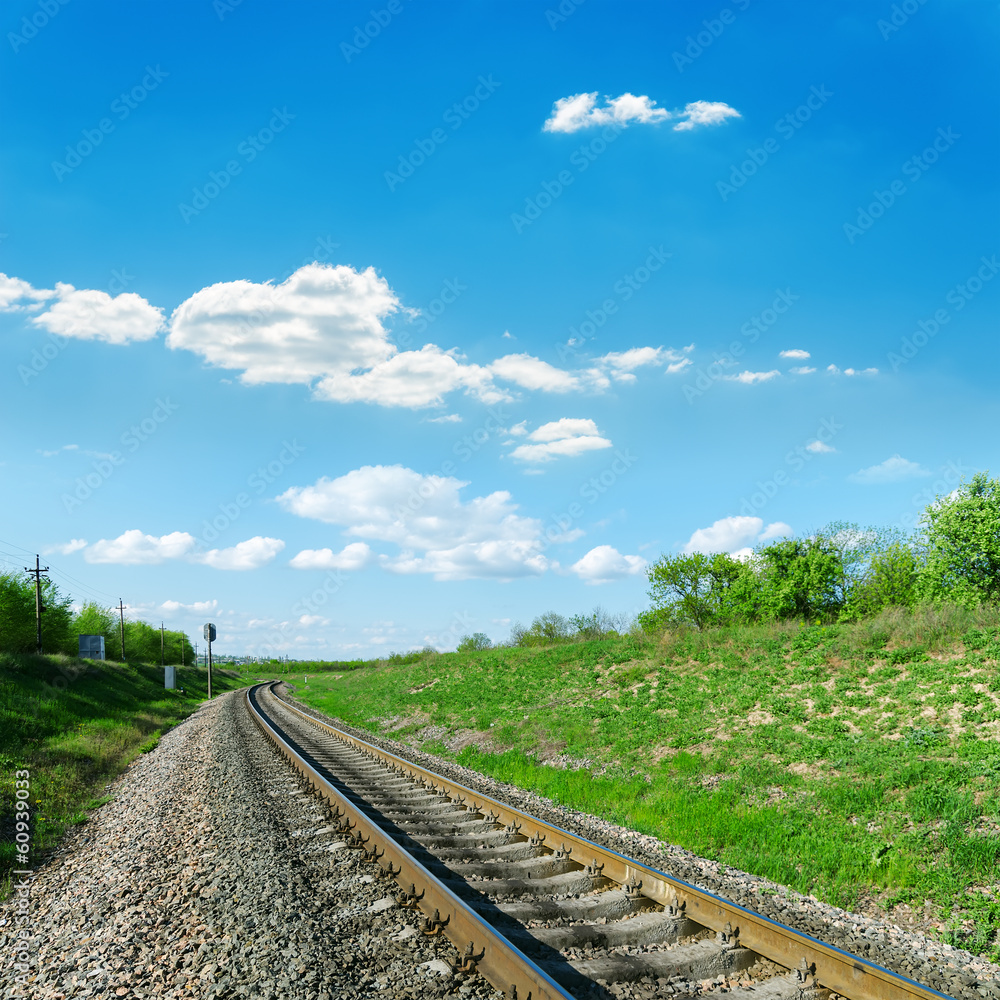 Fototapeta premium railroad in green landscape and blue sky