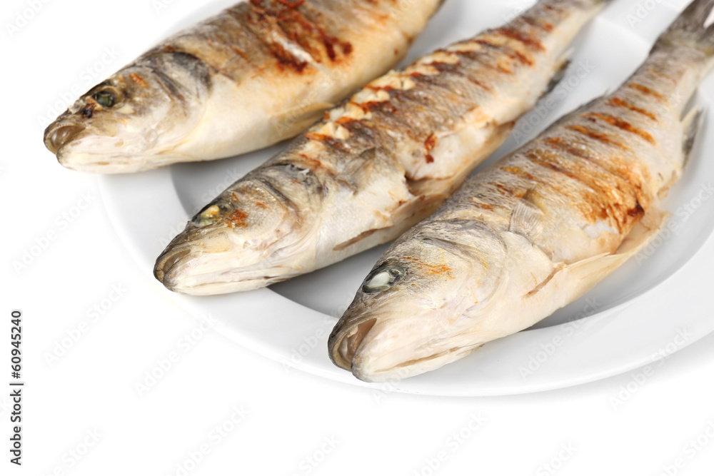 Delicious grilled fish on plate isolated on white Delicious grilled fish on plate isolated on white