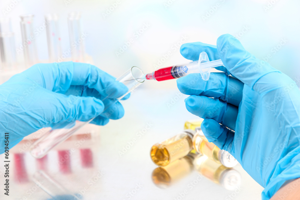 Technician injecting blood sample in test tube analysis, Technician injecting blood sample in test tube analysis,
