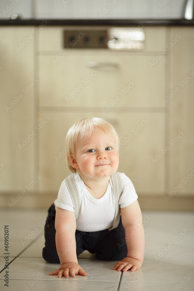 Little boy sitting on the floor and smiling. Little boy sitting on the floor and smiling.