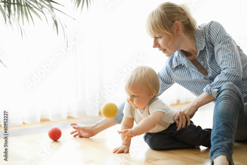 mother and son playing with small ball at home