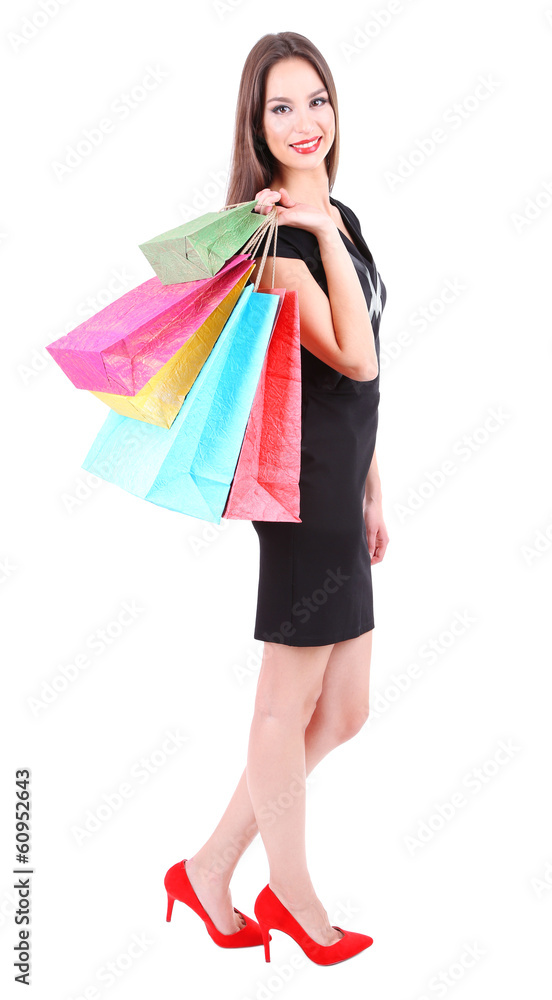 Beautiful young woman holding shopping bags isolated on white